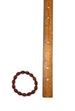 Wooden beaded bracelet next to a ruler on a white background