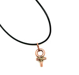 A small copper ankh necklace with a black cord cold copper cross hatch.
