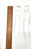 Wooden ruler next to three crystals on a white background