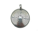 Silver pendant with intricate labrynth design on a white background