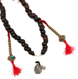 mala with bodhi seeds and charms in silver with side bead work turquoise and red coral.