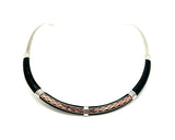 A black leather necklace with silver and copper detailing, featuring hand-hammered sterling silver inserts and copper elements, held together with sterling silver caps.