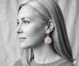 Copper and silver tree of life earrings on woman