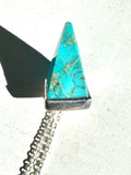 Turquoise pyramid shape pendant on silver chain.