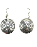 Pair of silver labyrinth earrings on a black card with a white background